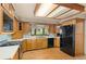 Well-lit kitchen features wooden cabinets and stainless steel fridge at 930 S Dayton St, Denver, CO 80247