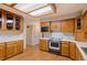 Kitchen with wooden cabinets and a drop-in range at 930 S Dayton St, Denver, CO 80247