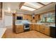 Kitchen features wooden cabinets and updated appliances at 930 S Dayton St, Denver, CO 80247