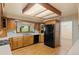 Bright kitchen with wooden cabinets and stainless steel fridge at 930 S Dayton St, Denver, CO 80247