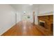 Bright living room boasts a brick fireplace and hardwood floors at 930 S Dayton St, Denver, CO 80247