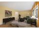 Bright living room features hardwood floors, large windows, and stylish decor at 930 S Dayton St, Denver, CO 80247