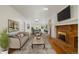 Cozy living room with a brick fireplace, hardwood floors, and skylights at 930 S Dayton St, Denver, CO 80247