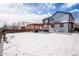 Large backyard with pergola, patio furniture, and snow on the ground at 580 Mount Massive St, Berthoud, CO 80513