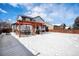 Spacious backyard with pergola, patio, and snow-covered lawn at 580 Mount Massive St, Berthoud, CO 80513