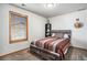 Cozy bedroom with a striped bedspread and built-in shelving at 580 Mount Massive St, Berthoud, CO 80513