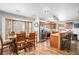 Kitchen dining area with a wood table and chairs, and a large window at 580 Mount Massive St, Berthoud, CO 80513
