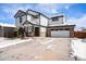 Two-story house with attached garage and snowy driveway at 580 Mount Massive St, Berthoud, CO 80513