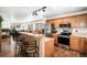 Open kitchen boasts stainless steel appliances and breakfast bar at 580 Mount Massive St, Berthoud, CO 80513