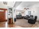 Bright living room with hardwood floors, fireplace, and leather seating at 580 Mount Massive St, Berthoud, CO 80513
