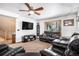 Spacious living room featuring a large TV and comfortable leather seating at 580 Mount Massive St, Berthoud, CO 80513