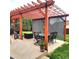 Relaxing patio with pergola, seating area, and built-in grill at 580 Mount Massive St, Berthoud, CO 80513