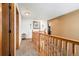 Upstairs hallway with wood railing and carpet at 580 Mount Massive St, Berthoud, CO 80513