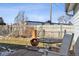 Backyard features a chiminea on the deck, a metal table, and a white rocking chair at 445 4Th St, Bennett, CO 80102