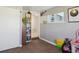 Bedroom features a window, a whiteboard, and an attached storage space with shelving at 445 4Th St, Bennett, CO 80102