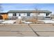 Charming home with a cozy front yard, showcasing a welcoming exterior, and some remnants of snow on the ground at 445 4Th St, Bennett, CO 80102