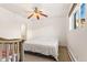 Spacious bedroom featuring a large bed and ceiling fan at 4653 S Lowell Blvd # B, Denver, CO 80236