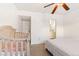 Bedroom with large bed, crib, and access to bathroom at 4653 S Lowell Blvd # B, Denver, CO 80236