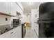Modern kitchen with white cabinets, granite counters, and stainless steel appliances at 4653 S Lowell Blvd # B, Denver, CO 80236