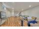 Open basement area with laminate floors, offering versatile space for recreation and relaxation at 3854 Perry St, Denver, CO 80212