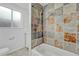 Cozy bathroom features a shower-tub with multicolored tiled walls and a white vanity at 3854 Perry St, Denver, CO 80212