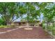 Beautiful brick duplex featuring lush trees, rock landscaping, and charming curb appeal at 3854 Perry St, Denver, CO 80212