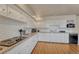 Updated kitchen with white cabinets, subway tile backsplash, laminate flooring, and stainless steel appliances at 3854 Perry St, Denver, CO 80212