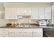 Traditional kitchen with white cabinets and dark countertops at 3854 Perry St, Denver, CO 80212