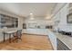 Bright kitchen featuring white cabinets, modern appliances, laminate flooring, and ample counter space at 3854 Perry St, Denver, CO 80212