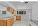 Bright kitchen with oak cabinets, light countertops, and white appliances at 3854 Perry St, Denver, CO 80212