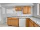 The kitchen has oak cabinets, light granite countertops and stainless steel appliances at 3854 Perry St, Denver, CO 80212