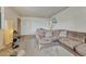 Cozy living room featuring carpeted floors, a brown sectional, and a welcoming atmosphere at 3854 Perry St, Denver, CO 80212