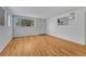 Living room featuring hardwood floors, white walls, and bright natural light at 3854 Perry St, Denver, CO 80212