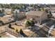 An aerial view reveals a large backyard with fence and mature landscaping, backing onto a quiet neighborhood at 1822 Painter Dr, Monument, CO 80132