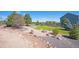 Backyard features a stone fire pit, rock garden and wood perimeter fence offering great space for outdoor entertaining at 1822 Painter Dr, Monument, CO 80132