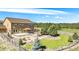 Aerial view of backyard featuring a covered patio, fire pit, and well-maintained landscaping at 1822 Painter Dr, Monument, CO 80132