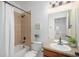 Bright bathroom featuring a shower-tub combo with tan tile and neutral decor at 1822 Painter Dr, Monument, CO 80132