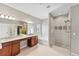 Bathroom featuring a double vanity, soaking tub, and a separate glass-enclosed shower at 1822 Painter Dr, Monument, CO 80132