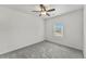Simple bedroom with one window, neutral carpet, and a ceiling fan at 1822 Painter Dr, Monument, CO 80132