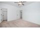 Neutral bedroom with a fan, closet, and an open doorway leading to a bright hall at 1822 Painter Dr, Monument, CO 80132