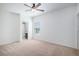 Neutral bedroom with a ceiling fan and views to a bathroom at 1822 Painter Dr, Monument, CO 80132
