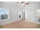 Light-filled bedroom with neutral tones, ceiling fan, and two large windows at 1822 Painter Dr, Monument, CO 80132