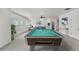 Bonus room features a pool table and views into the seating area, with natural light at 1822 Painter Dr, Monument, CO 80132