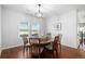 Classic dining room boasts hardwood floors, pendant lighting, and scenic window views at 1822 Painter Dr, Monument, CO 80132