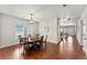 Dining room featuring hardwood floors, large windows, and an ornate pendant light at 1822 Painter Dr, Monument, CO 80132