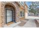 Front entrance featuring stone archway, a white door with window, and a concrete porch at 1822 Painter Dr, Monument, CO 80132