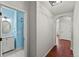 Hallway featuring hardwood floors, access to a bathroom, and an arched doorway at 1822 Painter Dr, Monument, CO 80132
