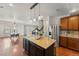 Open kitchen featuring a large island with seating, stainless steel appliances, and wood floors at 1822 Painter Dr, Monument, CO 80132