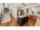 Modern kitchen featuring stainless steel appliances, island with seating, and hardwood floors at 1822 Painter Dr, Monument, CO 80132