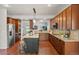 Spacious kitchen with stainless steel appliances, granite counters, large island, and hardwood floors at 1822 Painter Dr, Monument, CO 80132
